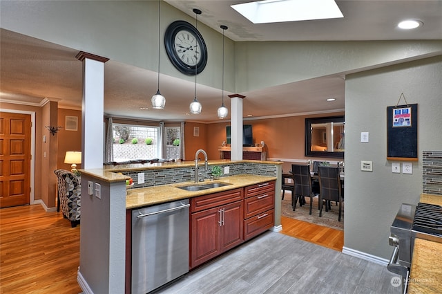 kitchen featuring dishwasher, sink, crown molding, decorative light fixtures, and light wood-type flooring