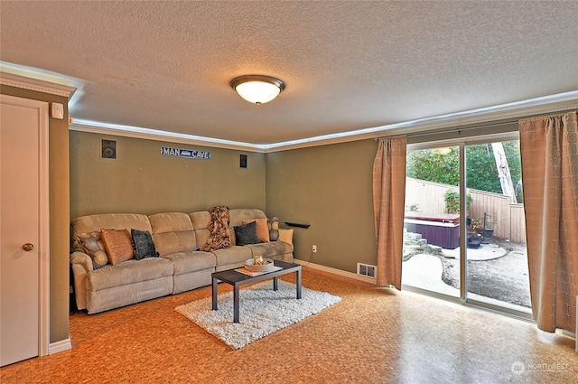 living room with crown molding and a textured ceiling