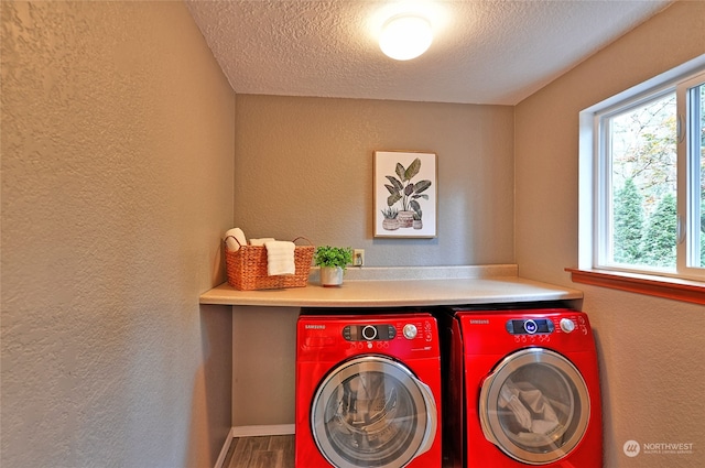 washroom featuring a textured ceiling, wood-type flooring, and washer and clothes dryer