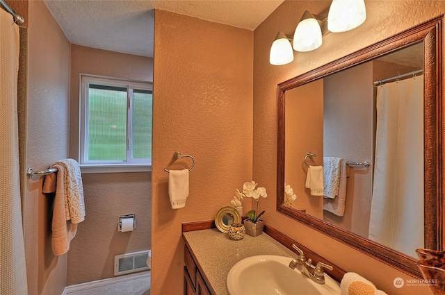 bathroom featuring vanity and a textured ceiling