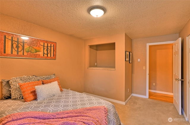 carpeted bedroom featuring a textured ceiling