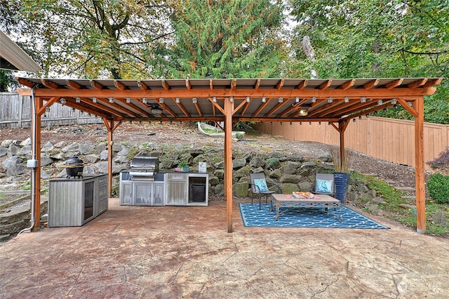 view of patio / terrace with area for grilling and a pergola