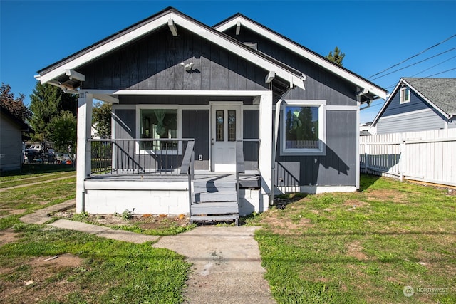 bungalow featuring a front yard and covered porch