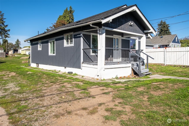 rear view of house with a yard