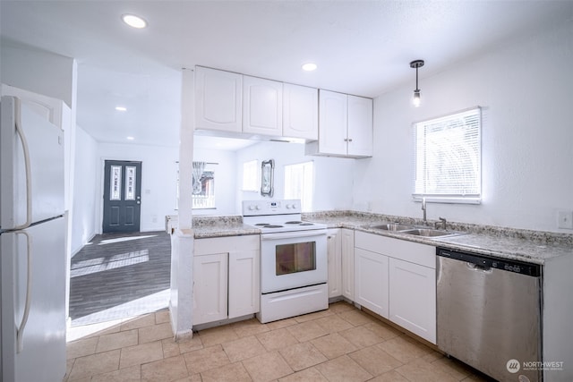 kitchen featuring white appliances, light hardwood / wood-style flooring, decorative light fixtures, sink, and white cabinets