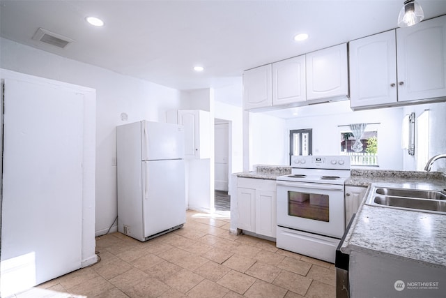 kitchen featuring sink, white appliances, and white cabinetry