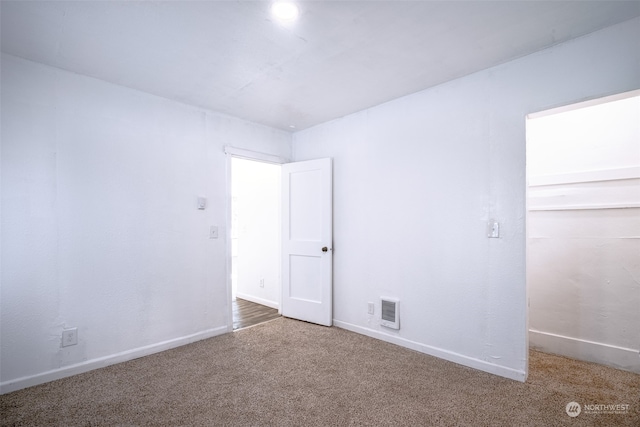 unfurnished room featuring carpet