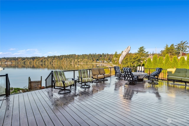 wooden terrace featuring a water view