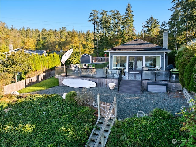 view of yard featuring an outdoor structure and a wooden deck