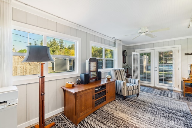 sunroom / solarium featuring french doors and ceiling fan