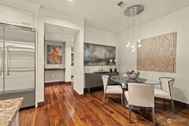 dining space featuring dark wood-type flooring