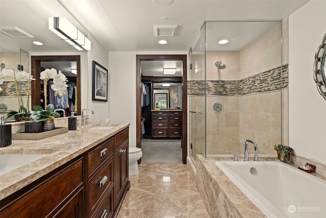 full bathroom with vanity, toilet, and separate shower and tub