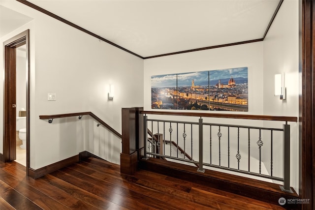 stairs featuring wood-type flooring and crown molding