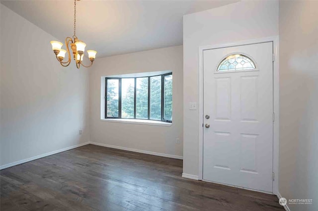 entrance foyer featuring dark hardwood / wood-style flooring and a chandelier