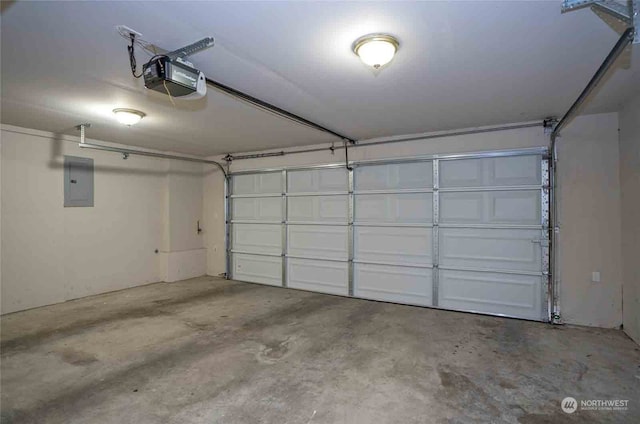 garage with a garage door opener and electric panel