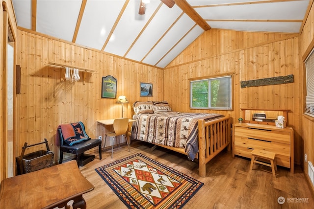 bedroom featuring wooden walls, vaulted ceiling with beams, and hardwood / wood-style floors