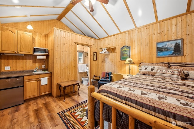 bedroom featuring lofted ceiling with beams, ceiling fan, sink, wooden walls, and dark hardwood / wood-style floors