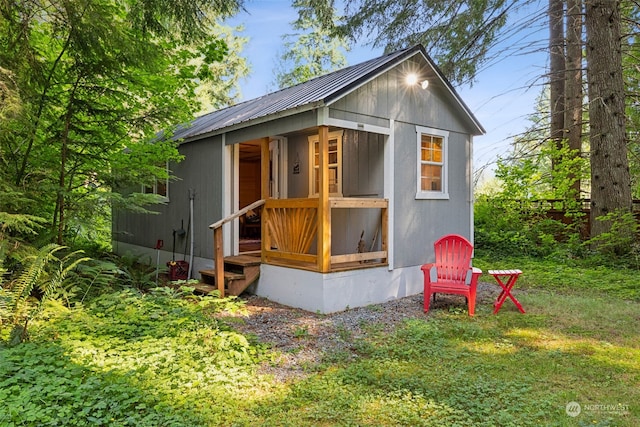 view of outbuilding featuring a yard