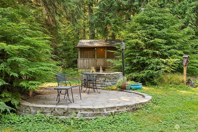 view of patio with an outbuilding