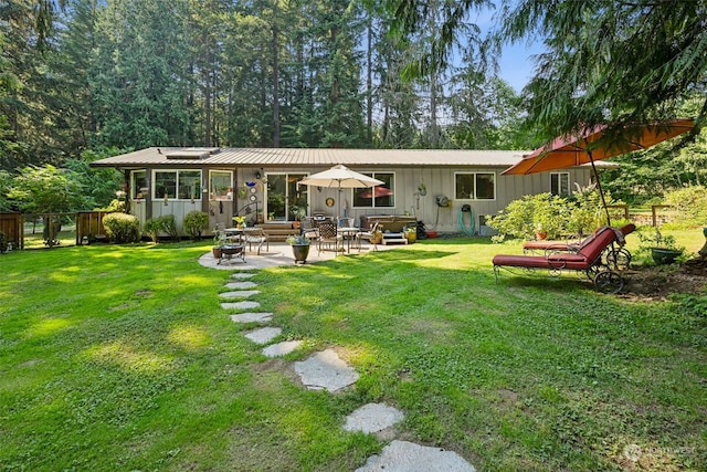 54611 278th Ave E, Ashford, WA 98304 - rear view of property featuring a patio area, metal roof, a yard, and board and batten siding
