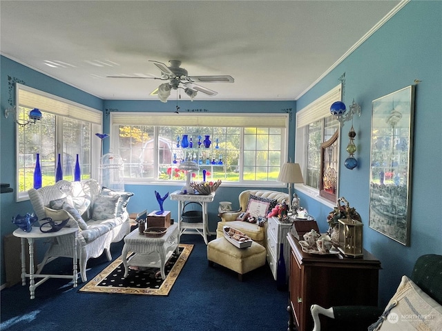 sitting room with a wealth of natural light, ornamental molding, and ceiling fan