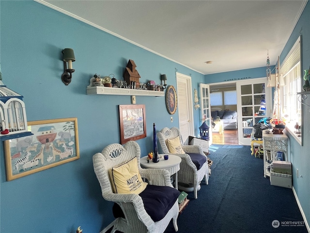 sitting room with french doors, crown molding, and carpet