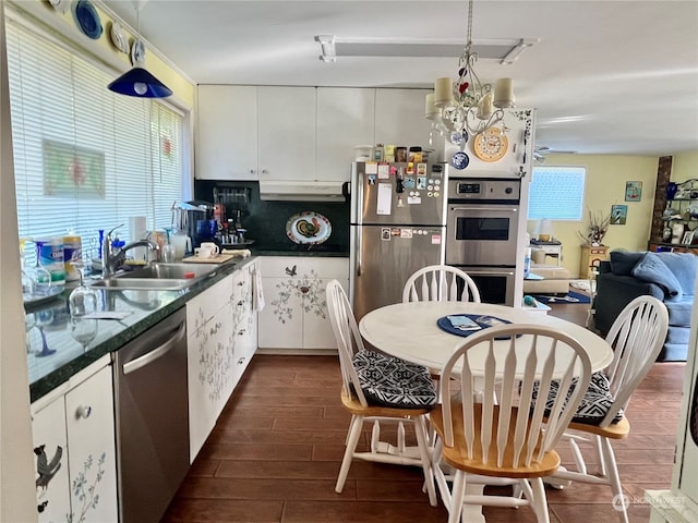 kitchen with white cabinetry, stainless steel appliances, dark wood-type flooring, and sink