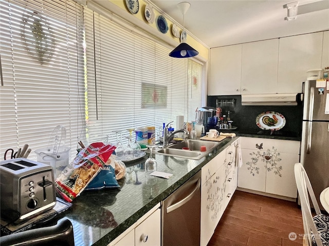 kitchen with appliances with stainless steel finishes, sink, pendant lighting, white cabinets, and dark wood-type flooring