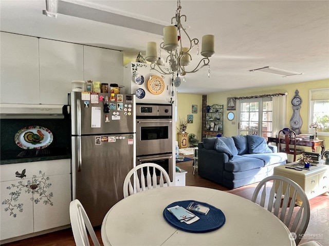 dining area featuring a notable chandelier and dark hardwood / wood-style flooring