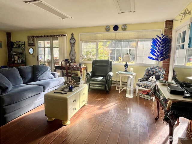 living room featuring hardwood / wood-style flooring, attic access, and baseboard heating