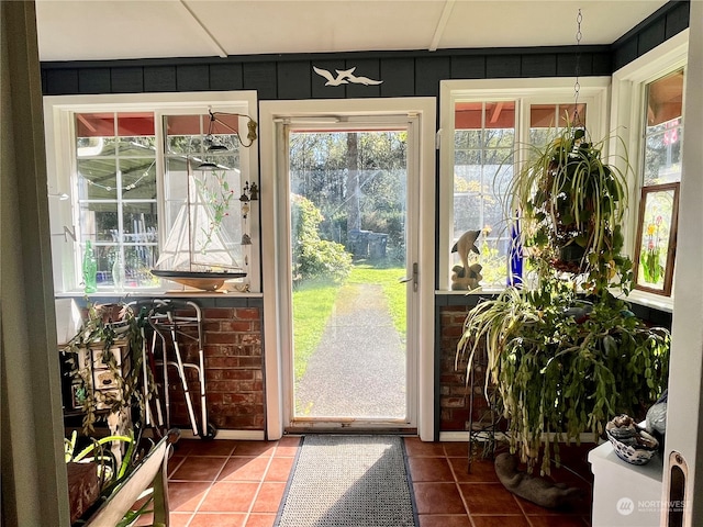 doorway to outside with tile patterned floors