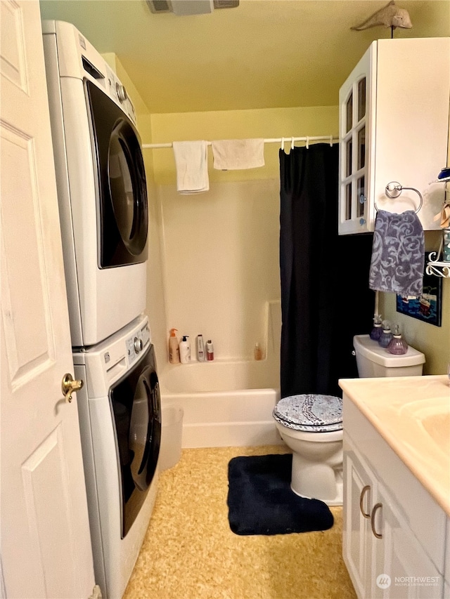 full bathroom featuring toilet, stacked washer / drying machine, vanity, and shower / bath combination with curtain