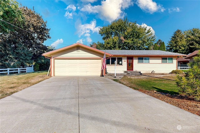 single story home featuring a garage and a front lawn