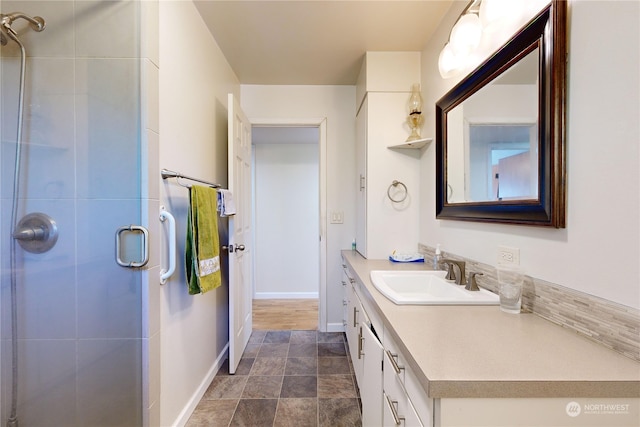 bathroom with vanity and a shower with shower door