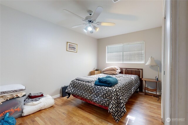 bedroom featuring hardwood / wood-style flooring and ceiling fan