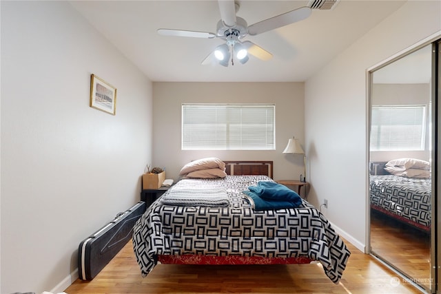 bedroom with wood-type flooring and ceiling fan