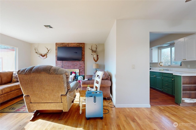 living room with sink and light wood-type flooring