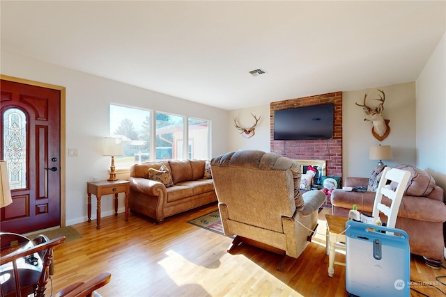 living room with a fireplace and light hardwood / wood-style floors