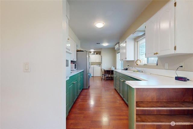 kitchen featuring stainless steel refrigerator, dark wood-type flooring, sink, and white cabinets