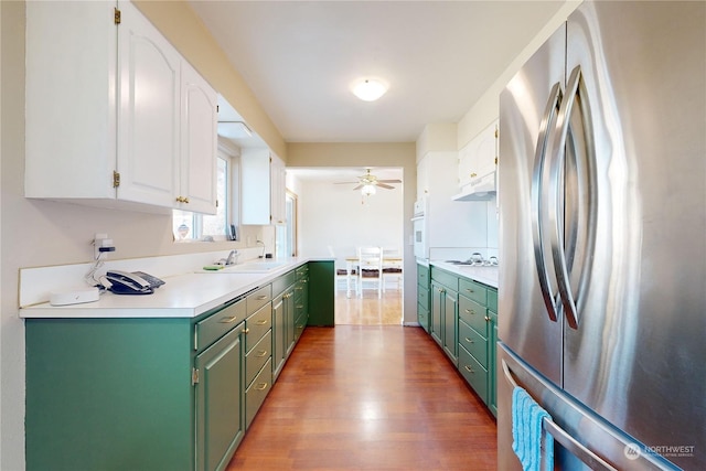 kitchen with dark hardwood / wood-style floors, white cabinetry, sink, ceiling fan, and white appliances