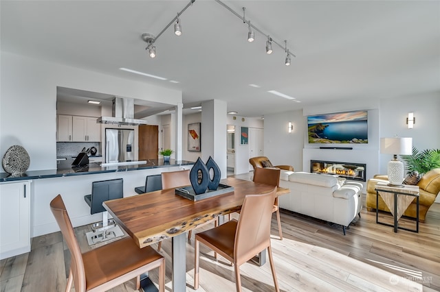 dining space with light hardwood / wood-style floors