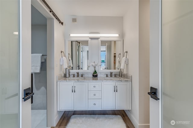 bathroom featuring vanity and wood-type flooring