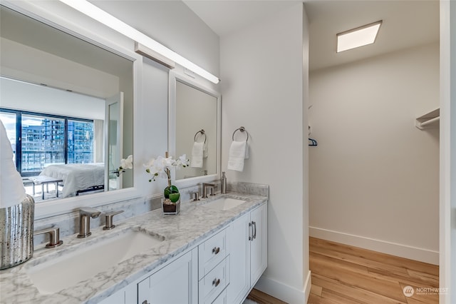 bathroom with vanity and hardwood / wood-style floors