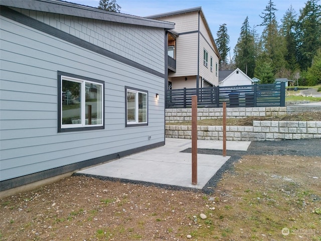 view of side of property with a patio