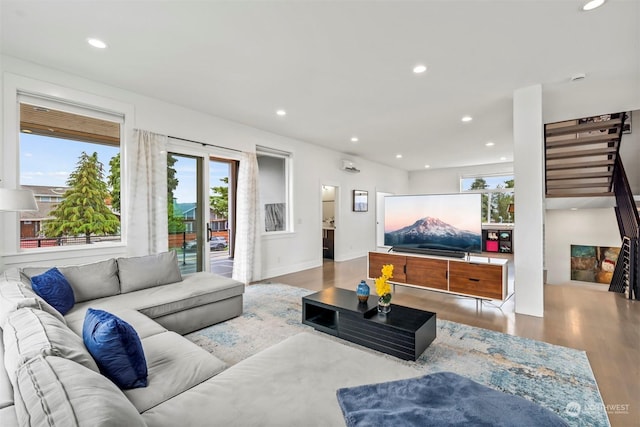 living room featuring baseboards, recessed lighting, plenty of natural light, and wood finished floors
