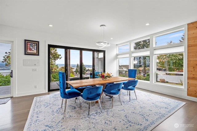 dining space with recessed lighting, dark wood-type flooring, a notable chandelier, and baseboards