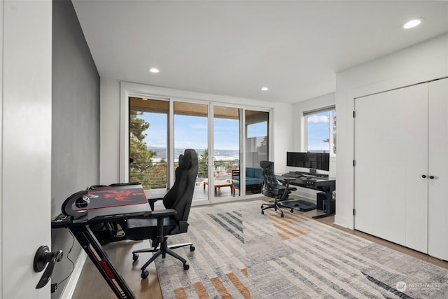 office with wood finished floors and recessed lighting