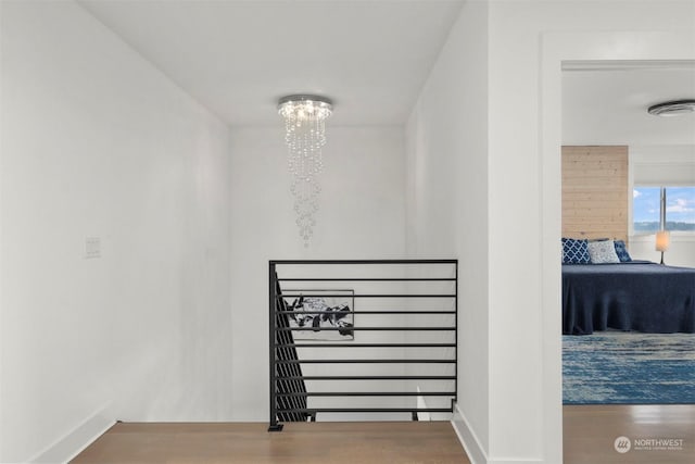 interior details featuring a notable chandelier, baseboards, visible vents, and wood finished floors