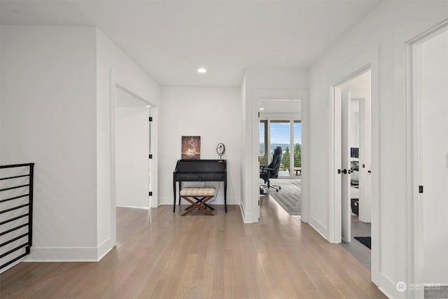 hallway featuring recessed lighting, baseboards, and wood finished floors