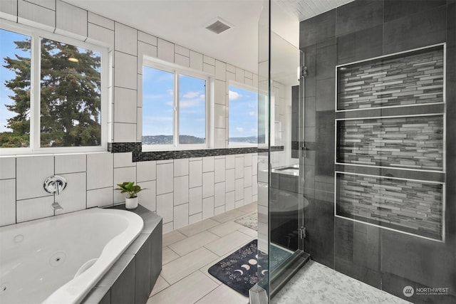 full bath with visible vents, tile patterned floors, a shower stall, and a jetted tub